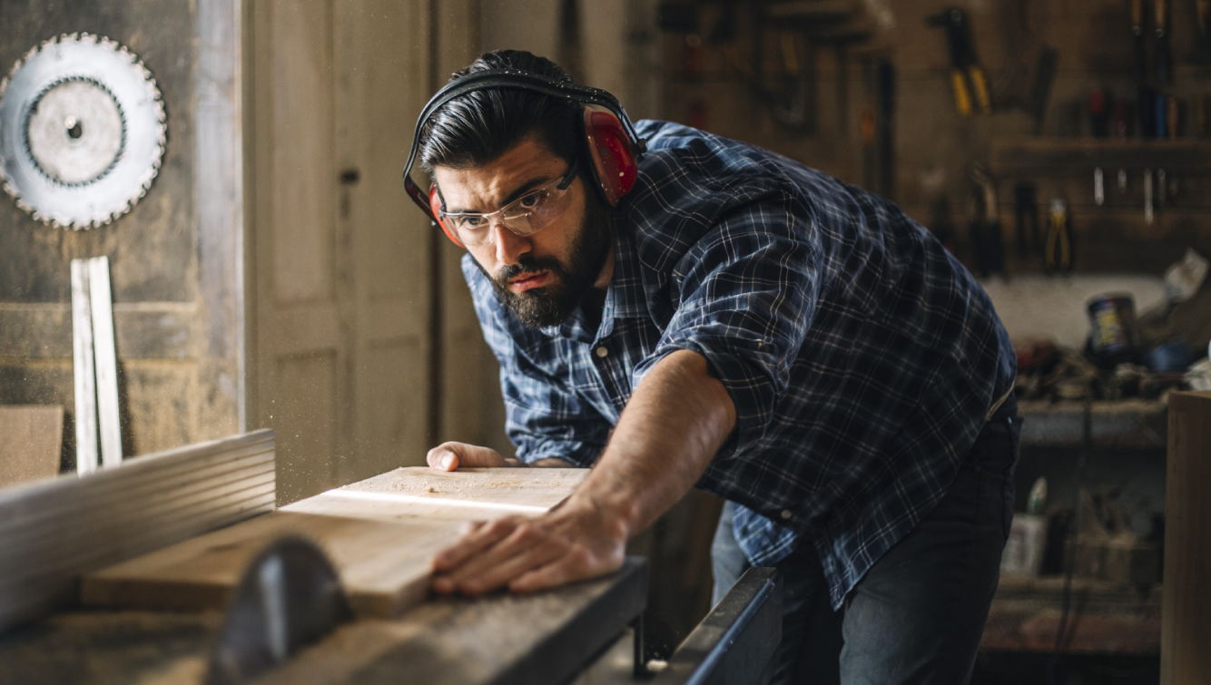 man cutting wood