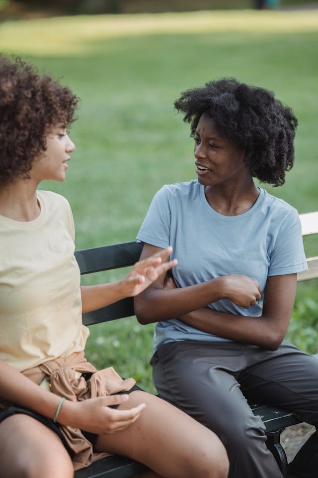 Une mère et son enfant assis sur un banc en train de discuter